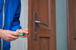 locksmith unscrew the door lock,locksmith repairs the lock in the front plastic door