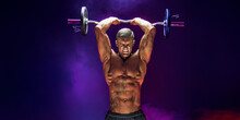 Brutal Sweaty Strong Young Man Athlete With Naked Upper Body Standing Doing Workout With Barbell And Showing Strong Pumped Up Biceps Over Smoky Background. Sport Men Body Concept