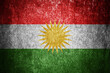 Closeup of grunge Kurdistan flag. Dirty Kurdistan flag on a metal surface