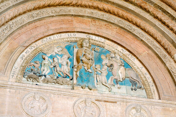 Wall Mural - Verona, Italy - lunette decorated with polychrome reliefs depicting the Madonna enthroned with Child; entrance portal of the cathedral of Santa Maria Assunta