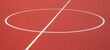 Sports court background. Top view to red artificial rubber ground with central circle field line with copy space