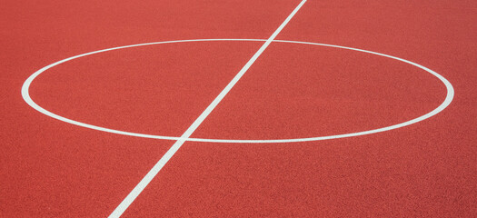 Wall Mural - Sports court background. Top view to red artificial rubber ground with central circle field line with copy space