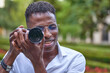 © JoseIMartin - Close up view of a man using a camera to take photos outdoors. Photography and hobbies concept.