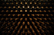 Wine bottles covered with dust in the wine cellar. Neatly aligned rows of bottles