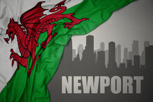 Abstract Silhouette Of The City With Text Newport Near Waving National Flag Of Wales On A Gray Background.