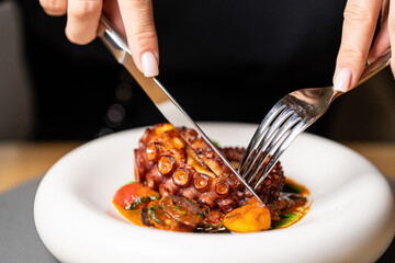 Sticker - Grilled octopus with small potatoes with herbs and spices. Top view with space for your text