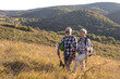 © pucko_ns - Active old woman and man walking at field and enjoy