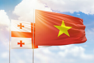 Sunny blue sky and flags of vietnam and georgia