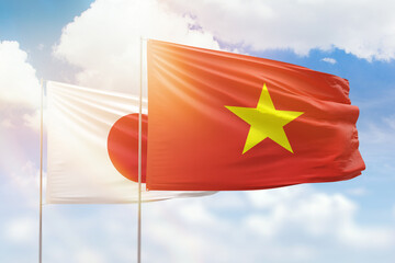 Wall Mural - Sunny blue sky and flags of vietnam and japan
