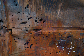 Wall Mural - Bullet and shrapnel holes in carcass of destroyed car