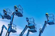 Articulated Boom Lift. Aerial Platform Lift. Telescopic Boom Lift Against Blue Sky. Mobile Construction Crane For Rent And Sale. Maintenance And Repair Hydraulic Boom Lift Service. Crane Dealership.