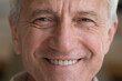 Optimistic healthy older man close up cropped face view. Portrait of smiling mature senior smiling looking at camera feels happy look overjoyed. Dentures, prosthesis, dental clinic services ad concept