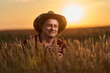 © Xalanx - Farmer at sunset in the wheat field at sunset