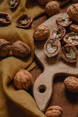 Wall Mural - Open half walnuts close up on a wooden board. Walnut kernel. Natural protein for healthy diet.