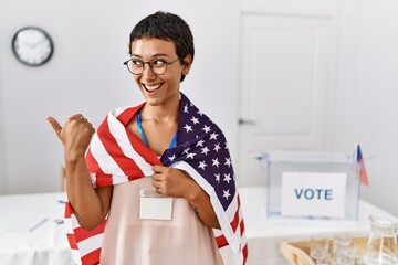 Sticker - Young hispanic woman with short hair at political campaign election holding usa flag pointing thumb up to the side smiling happy with open mouth