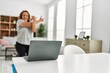 © Krakenimages.com - Middle age caucasian woman having stretching online class at home