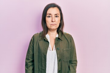 Canvas Print - Middle age hispanic woman wearing casual clothes with serious expression on face. simple and natural looking at the camera.