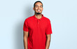 Young african american man wearing casual polo with a happy and cool smile on face. lucky person.
