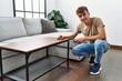 © Krakenimages.com - Young caucasian man smiling confident repairing table at home