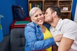 © Krakenimages.com - Mother and son sitting on sofa kissing at home