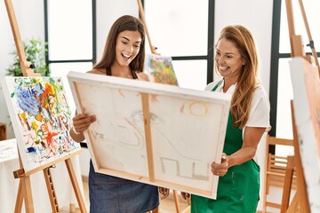 Poster - Mother and daughter smiling confident looking draw canvas at art studio