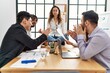 © Krakenimages.com - Businesswoman enjoys meditating during meeting. Sitting on desk near arguing partners at the office.