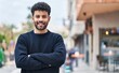 © Krakenimages.com - Young arab man smiling confident standing with arms crossed gesture at street