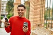 © Krakenimages.com - Handsome african american man outdoors using smartphone typing a message