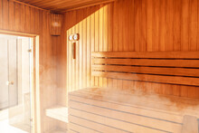 Interior Of Finnish Sauna, Classic Wooden Sauna With Hot Steam. Russian Bathroom. Relax In Hot Sauna With Steam. Wooden Interior Baths, Wooden Benches And Loungers Accessories For Sauna, Spa Complex