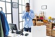 © Krakenimages.com - Young african man working as manager at retail boutique shocked covering mouth with hands for mistake. secret concept.