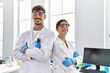 © Krakenimages.com - Man and woman partners wearing scientist uniform standing with arms crossed gesture at laboratory