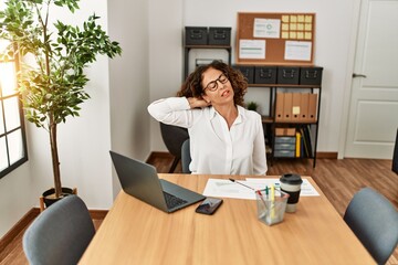 Poster - Middle age hispanic woman stretching and relaxing at office