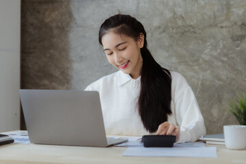 Wall Mural - Asian women working in the office, young Asian business women as business executives, founding and running start-up executives, young female business leaders. Startup business concept.