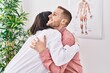 © Krakenimages.com - Man and woman doctor and patient hugging each other at clinic