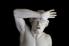 Greek Sculpture Of A Man With Raised Hand And Open Mouth Isolated On Black Background