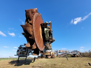 Poster - Bucket-wheel excavator Bagger in a reen field under the clear sky