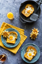 Fry Pan With A Fried Egg Sunshine Toast And Others On Plates, Ready For Eating.