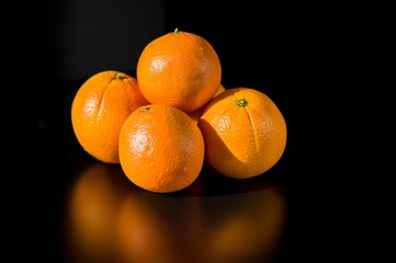 Canvas Print - Oranges composition over a black background