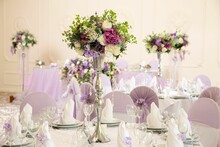 Wedding Decoration With Light Purple Flowers And Candles.