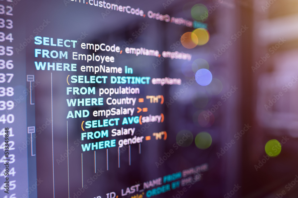 SQL (Structured Query Language) code on computer monitor and server room background. Example of SQL code to query data from a database.
