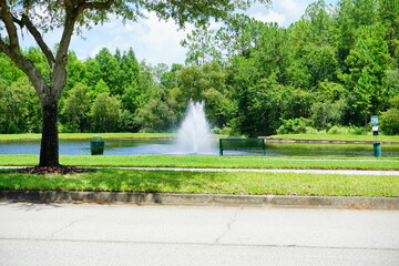 Poster - A Florida community pond and water front bench 
