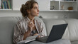 © stockbusters - Manager watching online training in pajamas closeup. Weekend leisure at home