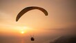 © Hanif Setiawan/Wirestock Creators - Tandem paragliding closeup over sea and beach while golden sunset