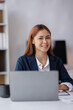 © David - Asian Business woman using calculator and laptop for doing math finance on an office desk, tax, report, accounting, statistics, and analytical research concept