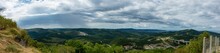 Panoramic View Of Green Mountains Of Crni Kal Village Under A Cloudy Sky In Slovenia