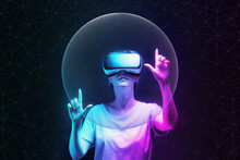 Metaverse And 3D Simulation. Portrait Of Young Woman In VR Glasses Creates Mesh Sphere. Dark Background With Neon Abstracts. The Concept Of Virtual Reality And Futurism