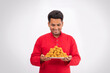 © Prkash Pictures - smiling man looking and holding plate full of laddoos