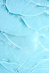 Wall Mural - Water blue background water with waves and ripples. Cosmetic background concept