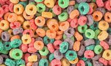Delicious And Nutritious Fruit Cereal Loops As Background, Top View. Healthy Breakfast.