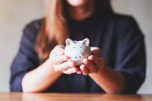 Closeup Image Of A Woman Holding A Piggy Bank For Saving Money And Financial Concept